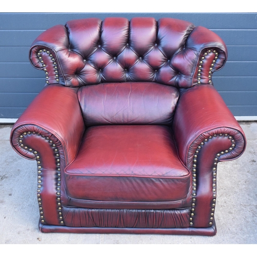 404 - Red oxblood leather Chesterfield-style button-back armchair with metal beading, 110x96x92cm tall.