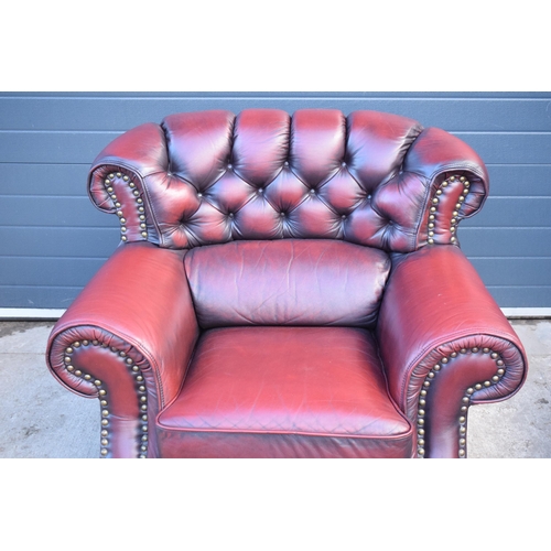 404 - Red oxblood leather Chesterfield-style button-back armchair with metal beading, 110x96x92cm tall.