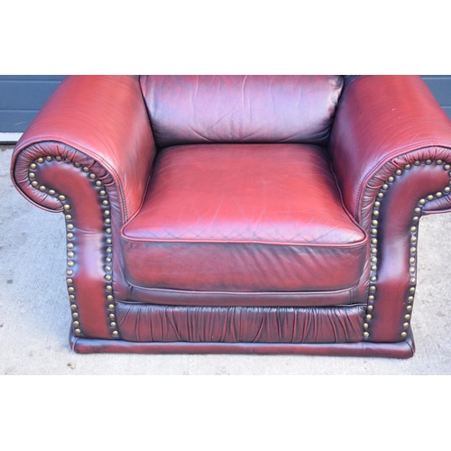 404 - Red oxblood leather Chesterfield-style button-back armchair with metal beading, 110x96x92cm tall.