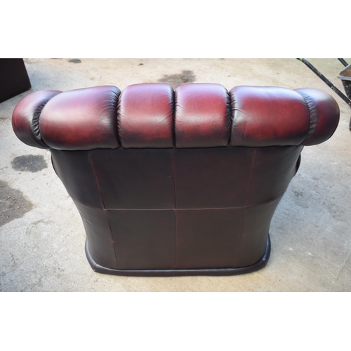 404 - Red oxblood leather Chesterfield-style button-back armchair with metal beading, 110x96x92cm tall.