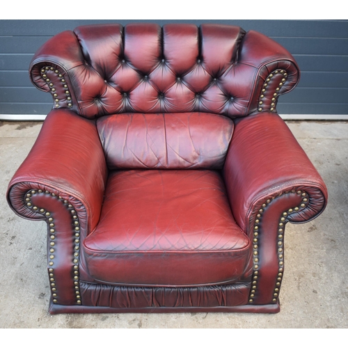 405 - Red oxblood leather Chesterfield-style button-back armchair with metal beading, 110x96x92cm tall.