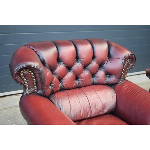 405 - Red oxblood leather Chesterfield-style button-back armchair with metal beading, 110x96x92cm tall.