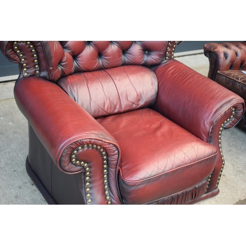 405 - Red oxblood leather Chesterfield-style button-back armchair with metal beading, 110x96x92cm tall.