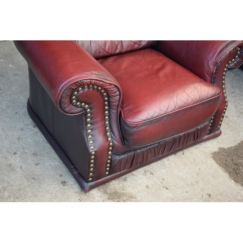 405 - Red oxblood leather Chesterfield-style button-back armchair with metal beading, 110x96x92cm tall.