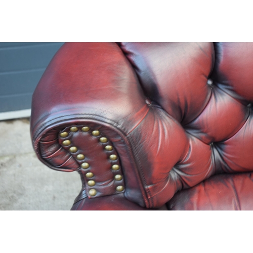 405 - Red oxblood leather Chesterfield-style button-back armchair with metal beading, 110x96x92cm tall.