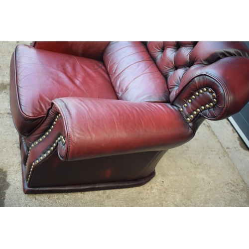 405 - Red oxblood leather Chesterfield-style button-back armchair with metal beading, 110x96x92cm tall.