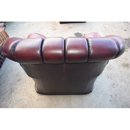 405 - Red oxblood leather Chesterfield-style button-back armchair with metal beading, 110x96x92cm tall.