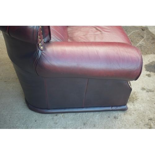 405 - Red oxblood leather Chesterfield-style button-back armchair with metal beading, 110x96x92cm tall.