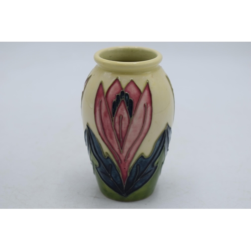 102K - Moorcroft vase on cream background with floral design, 10.5cm tall.