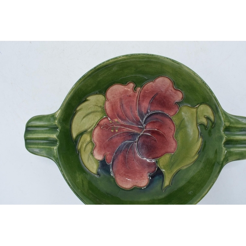 102P - Moorcroft Hibscus on green double handled bowl / dish with ribbed handles, 22cm diameter, in the sty... 