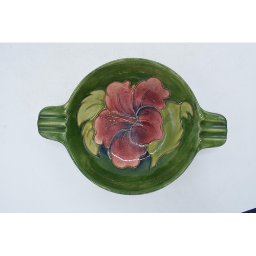 102P - Moorcroft Hibscus on green double handled bowl / dish with ribbed handles, 22cm diameter, in the sty... 