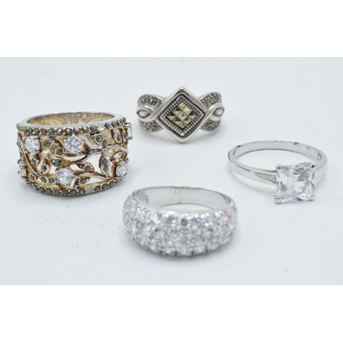 180C - A collection of 4 silver rings of varying designs (4).