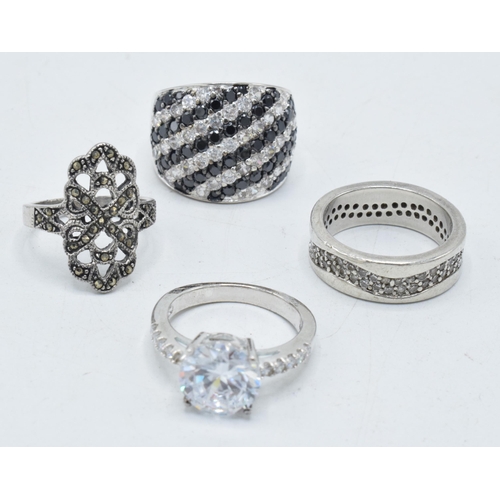 180D - A collection of 4 silver rings of varying designs (4).