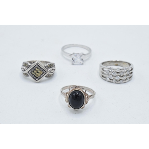 180F - A collection of 4 silver rings of varying designs (4).