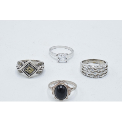 180F - A collection of 4 silver rings of varying designs (4).