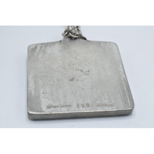 180I - Jorgen Jensen pewter pendant, marked 'Jorgen Jensen Denmark 299' on white metal chain, 4.5cm diamete... 