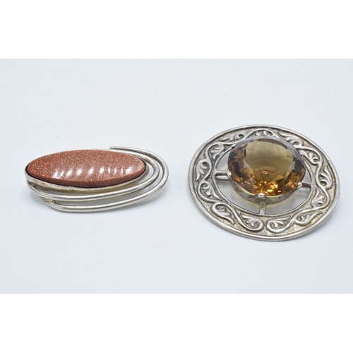 180N - Silver Celtic citrine-style brooch together with a silver galastone brooch (2).