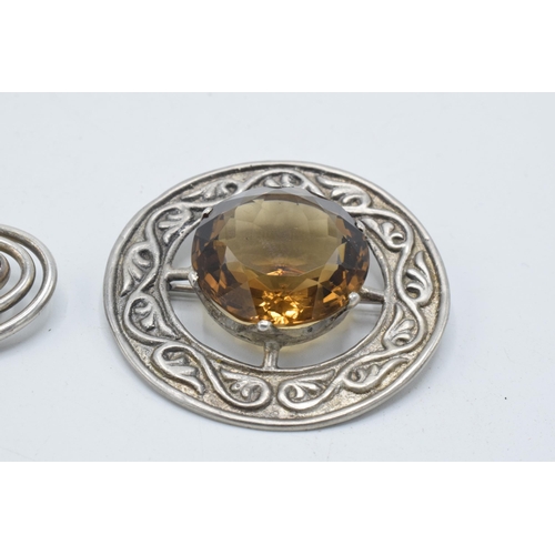 180N - Silver Celtic citrine-style brooch together with a silver galastone brooch (2).