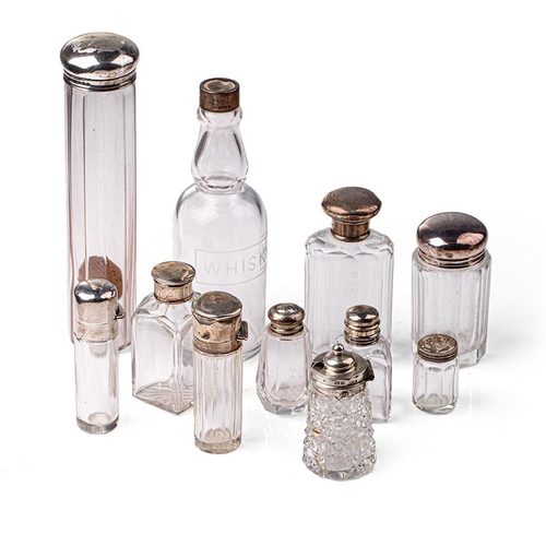 101 - A collection of hallmarked silver topped glass containers to include cruets, perfume and others (11)... 