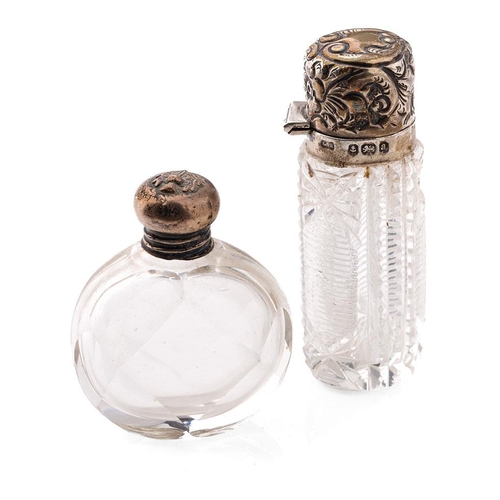 107 - A pair of silver topped scent bottles, one with oval shape, the other bright-cut glass, both early 2... 