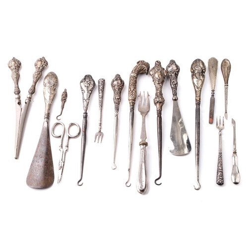 113 - A good collection of silver-handled items to include scissors, knives, button hooks etc (Qty).