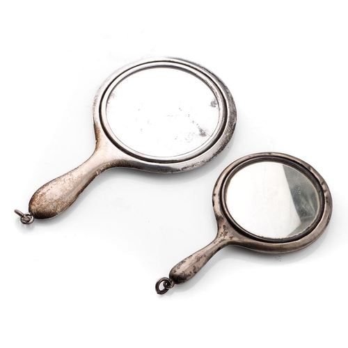 115 - A pair of miniature silver hand mirrors, largest 11cm long, hallmarks rubbed (2).