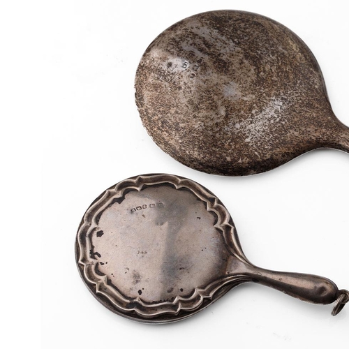 115 - A pair of miniature silver hand mirrors, largest 11cm long, hallmarks rubbed (2).