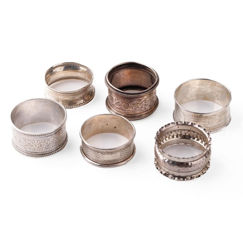 126 - A collection of hallmarked silver napkin rings of varying ornate designs, 76.0 grams (6).