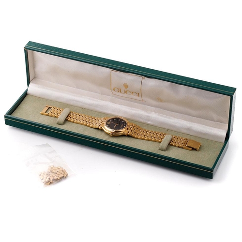 242 - Boxed gold plated Gucci quartz wristwatch, black dial set with diamonds and calendar, model no. 9200... 