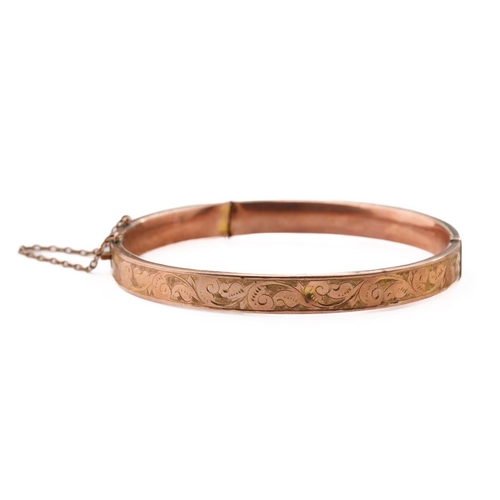 318 - 9ct rose gold bangle with engraved decoration, 8.8 grams, split to rear, 65mm diameter.