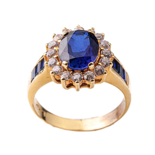 334 - 18ct gold ring set with a large sapphire and CZs cluster ring, shoulders set with sapphires (possibl... 