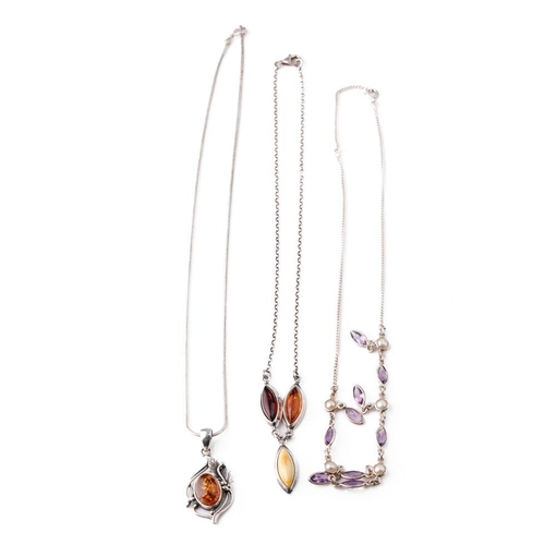 382 - A trio of silver ladies necklaces with pendants to include amber-style items and amethyst coloured s... 