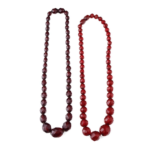 387 - A pair of vintage bakelite cherry amber (or similar) graduated necklaces with faceted beads, each ap... 