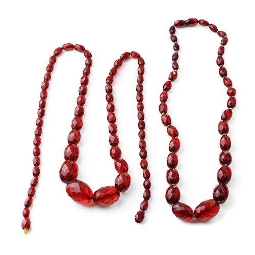 388 - A pair of vintage bakelite cherry amber (or similar) graduated necklaces with faceted beads, longest... 