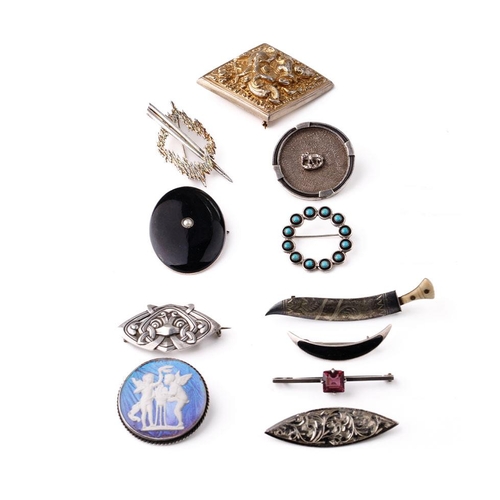 404 - A collection of silver brooches to include a silver gilt Indian brooch, a Scandinavian examples and ... 