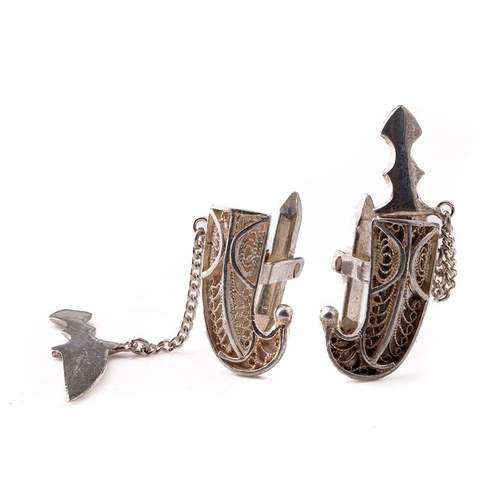 448 - A pair of white metal cufflinks in the form of daggers (2).