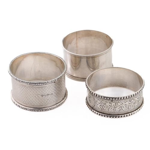 80 - A trio of silver napkin rings to include William Thorneymark Birmingham 1900, Robert Pringle & Sons ... 