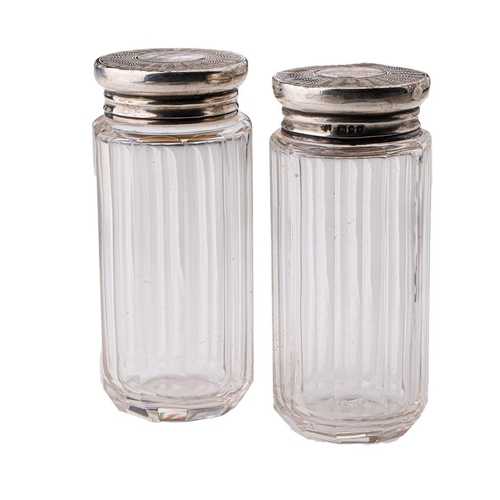 94 - A pair of silver topped dressing table jars, 9.5cm tall, London 1910 (2).