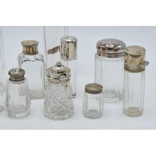 101 - A collection of hallmarked silver topped glass containers to include cruets, perfume and others (11)... 