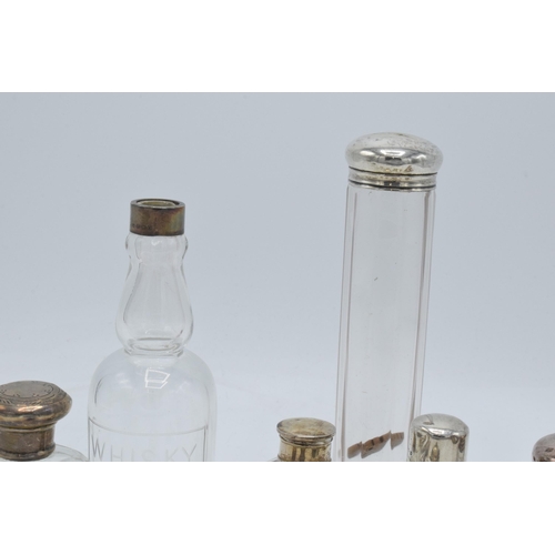 101 - A collection of hallmarked silver topped glass containers to include cruets, perfume and others (11)... 