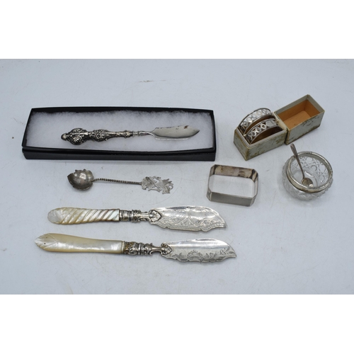 105 - A collection of silver items to include a pair of silver and Mother of Pearl handled fish knives, Bi... 