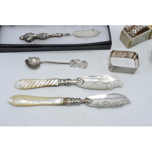 105 - A collection of silver items to include a pair of silver and Mother of Pearl handled fish knives, Bi... 