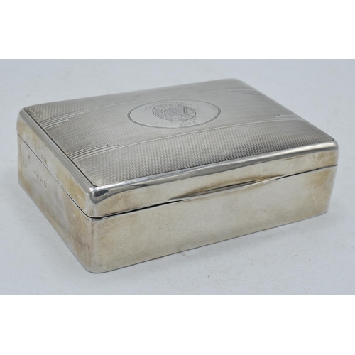 106 - Silver cigarette box with engineered decoration and crest 'The Chad Valley Co Ltd Dinner 1933', 12.5... 