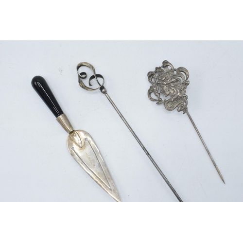 117 - A trio of silver items to include a Charles Horner stick pin, a maiden stick pin and a miniature cak... 