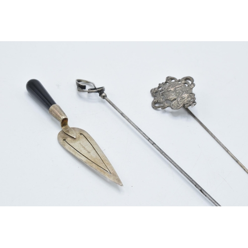 117 - A trio of silver items to include a Charles Horner stick pin, a maiden stick pin and a miniature cak... 