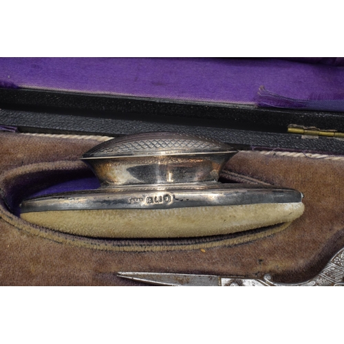 122 - Silver handled manicure set with 8 pieces to include a nail buffer, lidded jar, nail file and others... 