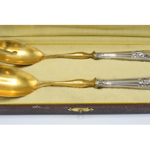 123 - A cased pair of late 19th century silver and gilt metal salad servers, probably European, with indis... 