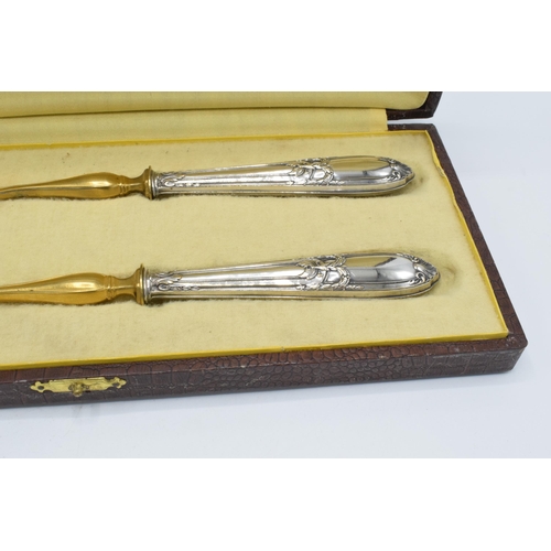 123 - A cased pair of late 19th century silver and gilt metal salad servers, probably European, with indis... 