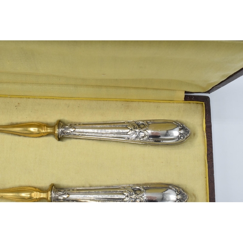 123 - A cased pair of late 19th century silver and gilt metal salad servers, probably European, with indis... 