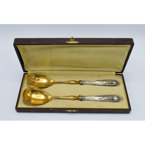 123 - A cased pair of late 19th century silver and gilt metal salad servers, probably European, with indis... 